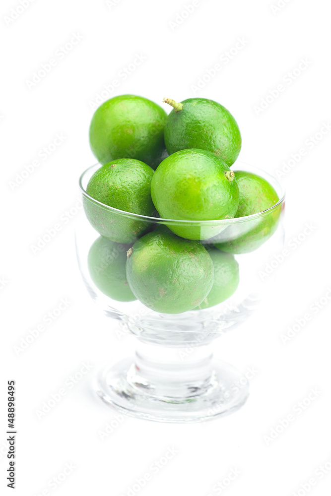 lime in a glass bowl isolated on white lime in a glass bowl isolated on white