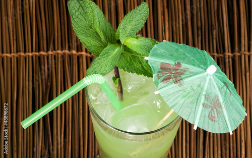 Green cocktail with cubes ice photo