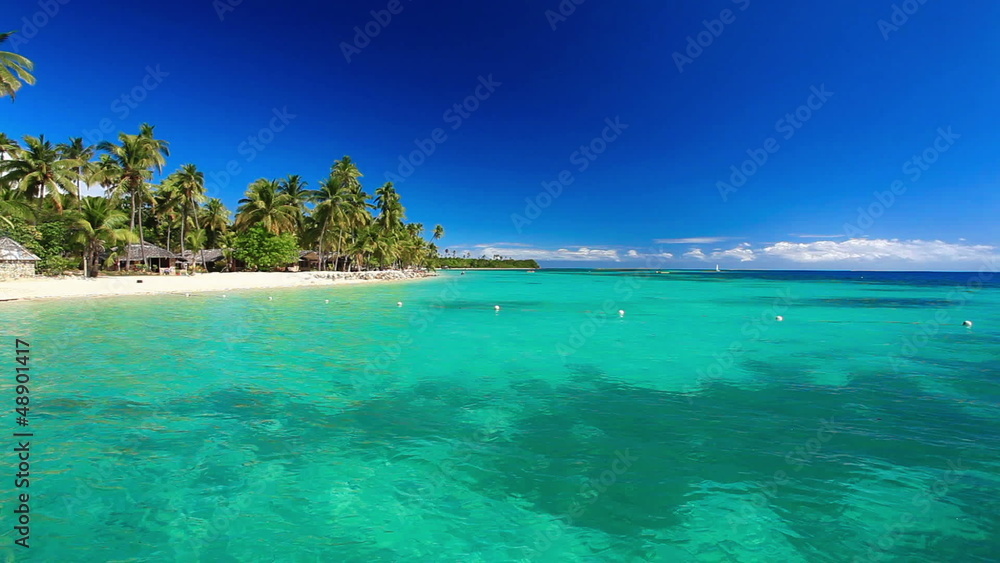 Few palm trees over tropical lagoon with white beach Few palm trees over tropical lagoon with white beach