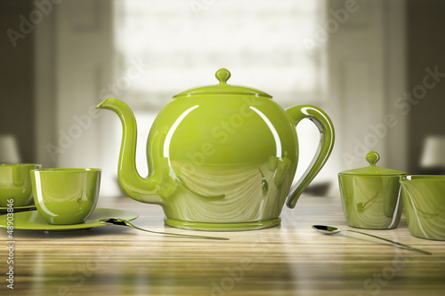 Green teapot and teacups photo