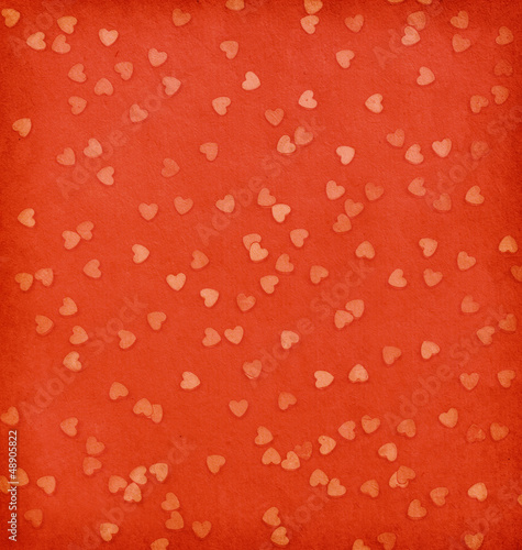 aged paper texture.  Hearts on  red paper.