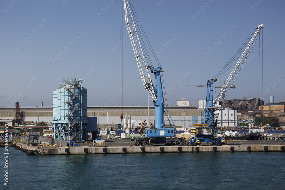 Big steel factory with harbor at the Italian coast