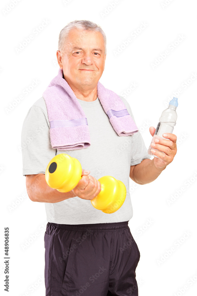A mature man exercising with a dumbbell and holding a bottle of A mature man exercising with a dumbbell and holding a bottle of