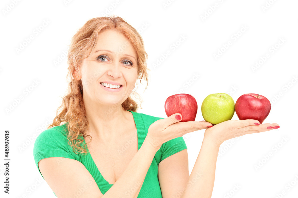 Mature beautiful woman sitting and holding three apples Mature beautiful woman sitting and holding three apples