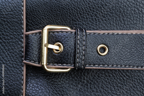 Belt buckles and textured black leather.