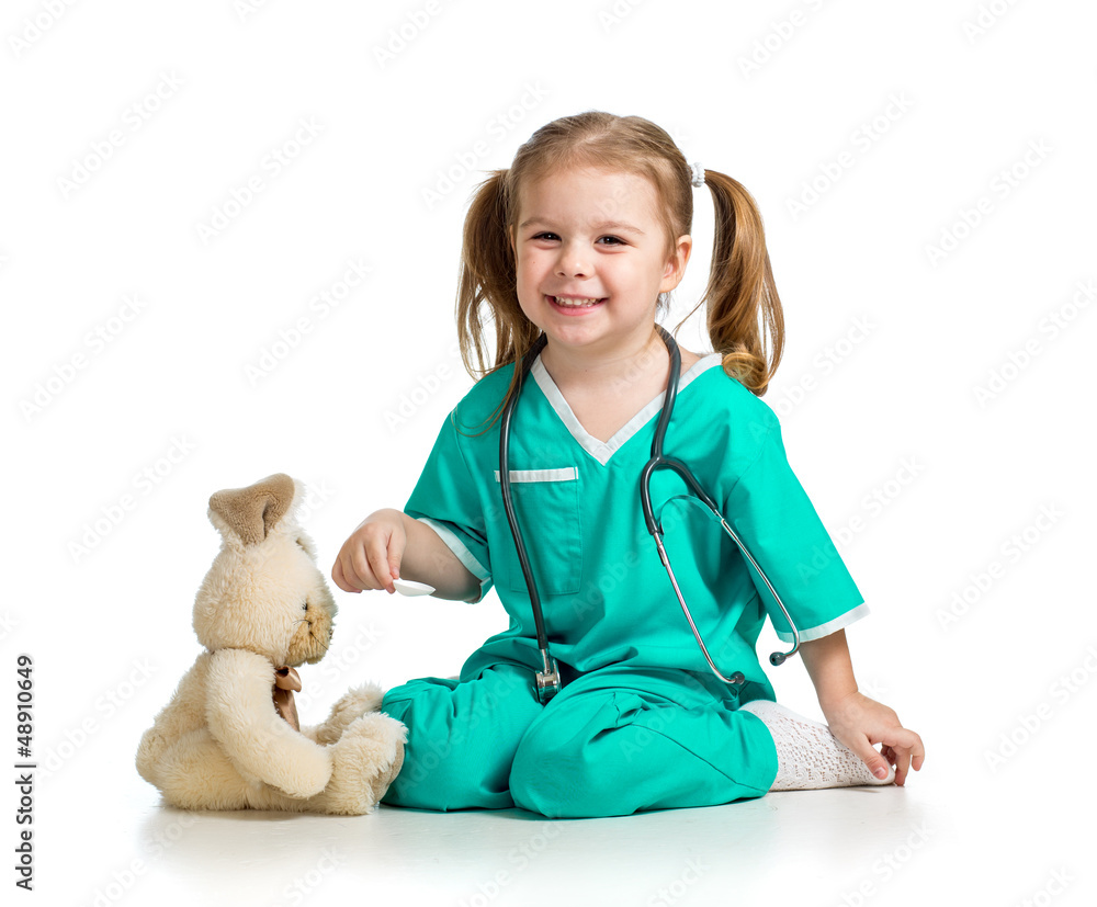 Adorable girl with clothes of doctor playing with toy over white Adorable girl with clothes of doctor playing with toy over white