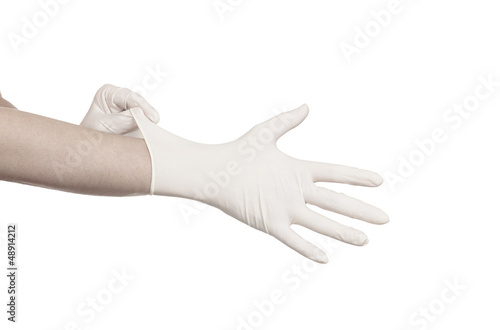 Fototapeta Naklejka Na Ścianę i Meble -  Pulling on surgical glove
