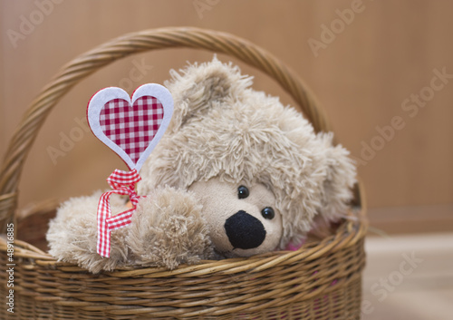 teddy bear holding  heart in  basket Valenyine's day