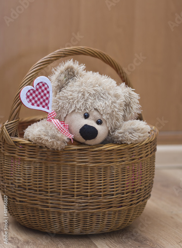 teddy bear holding  heart in  basket Valenyine's day