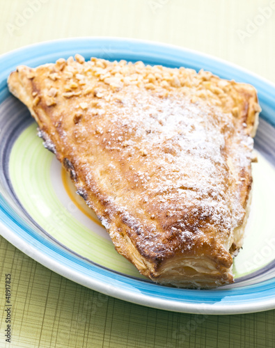 triangular pastry cream filling, on plate on yellow base