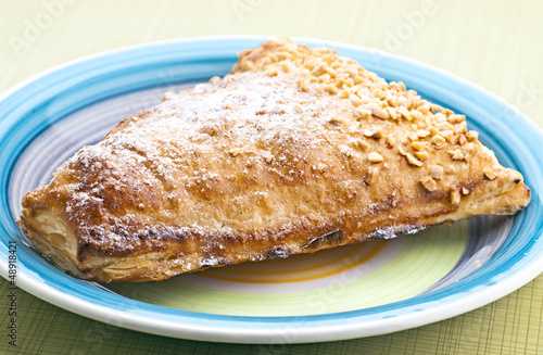 triangular pastry cream filling, on plate on yellow base