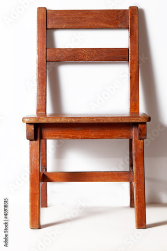 wood chair with white wall in background