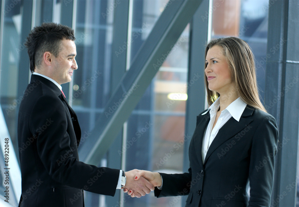 A couple of young business persons shaking hands A couple of young business persons shaking hands