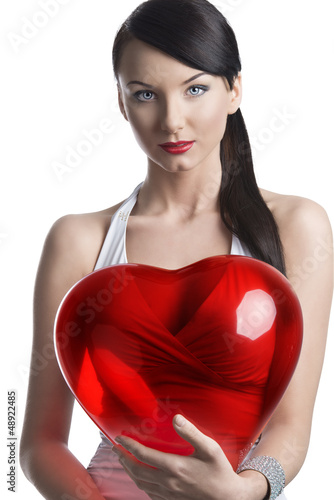 sexy brunette with heart shaped balloon looks in to the lens