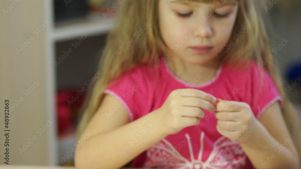 Child making jewelry from beads. Closeup portrait Child making jewelry from beads. Closeup portrait