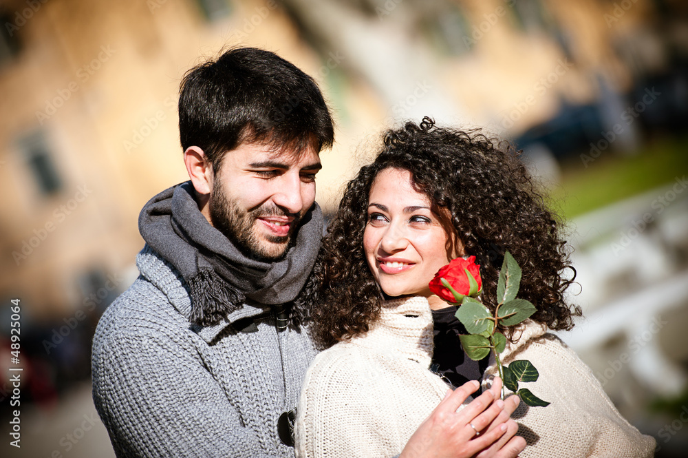 Young couple with rose, outdoors Young couple with rose, outdoors