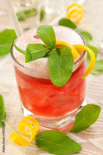 Red drink with decoration sage