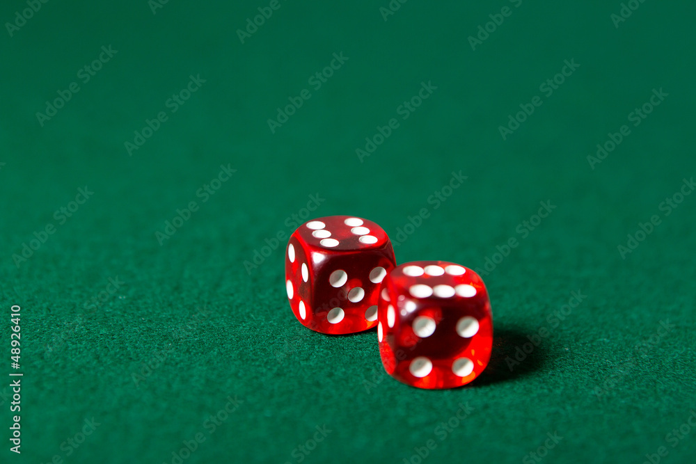 Two red dices on the poker table Two red dices on the poker table
