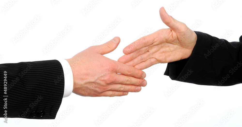 Closeup of male and female executives about to shake hands Closeup of male and female executives about to shake hands