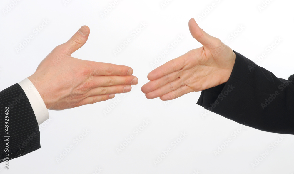 Closeup of male and female executives about to shake hands