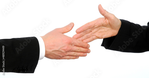 Closeup of male and female executives about to shake hands