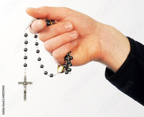 Closeup of man's hands holding  rosary