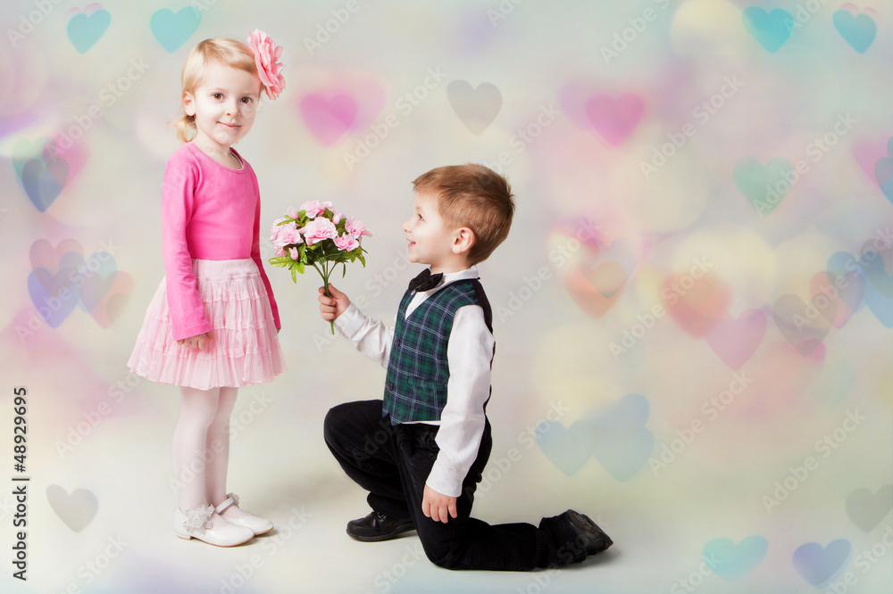 Little boy giving flowers to girl Little boy giving flowers to girl