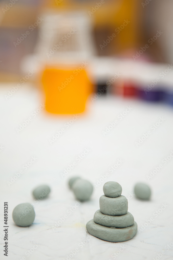 Small clay toys and paint on a table Small clay toys and paint on a table