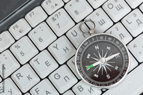 Computer keyboard and retro compass, business decision