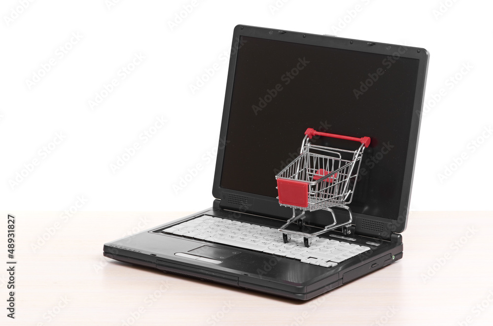 Online shopping. trolley on laptop