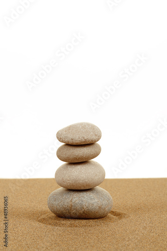 Balance zen stones in sand on white