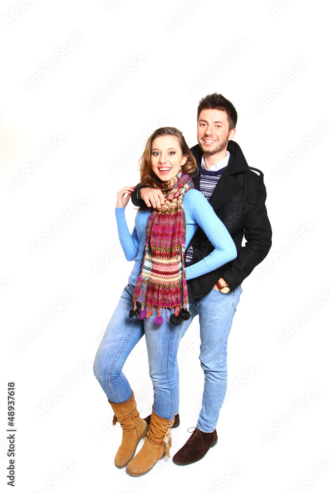 Fashion young couple in winter clothes isolated on white backgro Fashion young couple in winter clothes isolated on white backgro