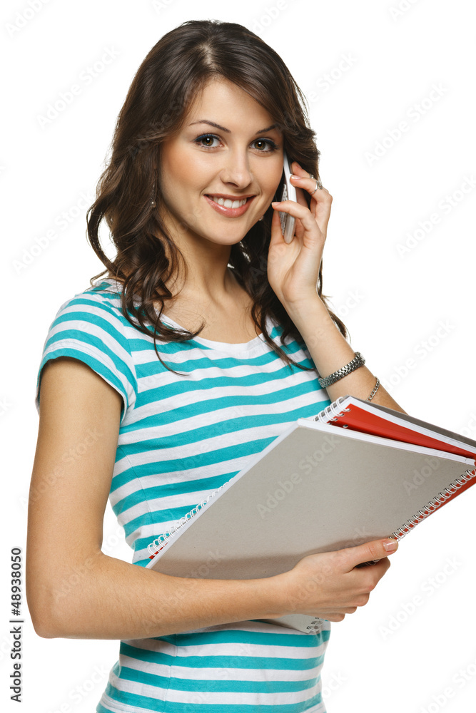 Young woman holding folders talking on mobile phone Young woman holding folders talking on mobile phone