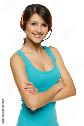 Smiling woman in headset standing with folded hands