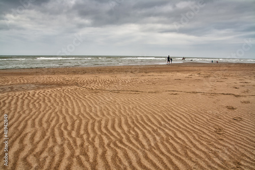 Sandy beach with dark clouds