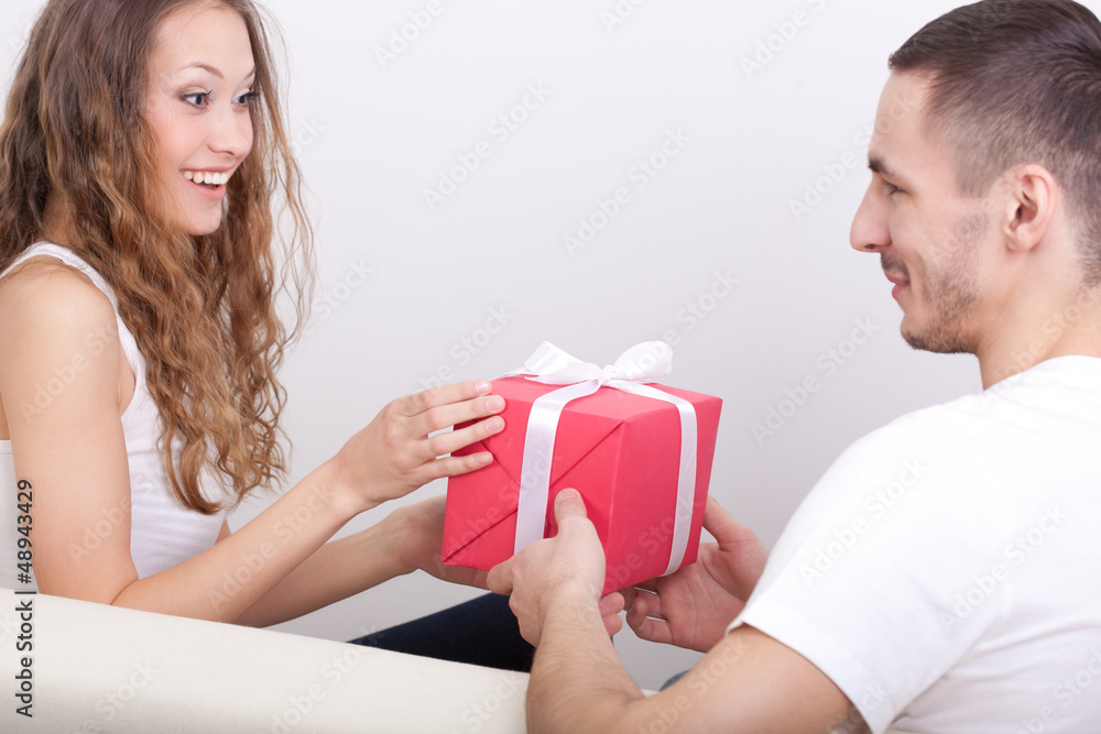 young man giving box for his girlfriend young man giving box for his girlfriend