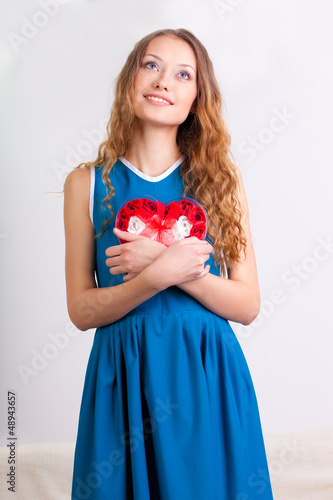 young woman holding heart shaped box