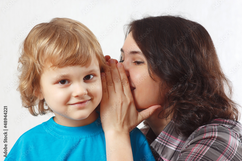 Mother whispers something to her little son Mother whispers something to her little son