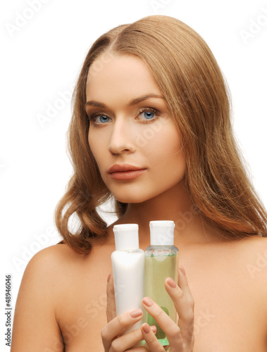 woman with cosmetic bottles
