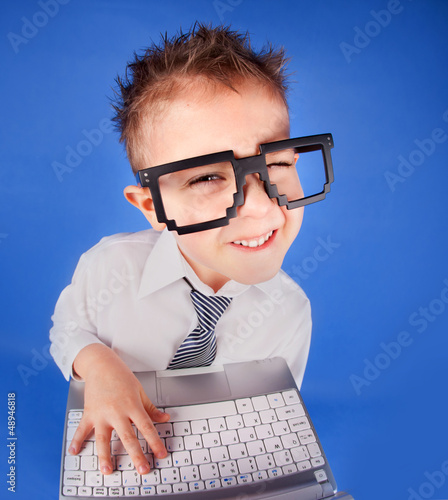 Five years old boy with a laptop computer