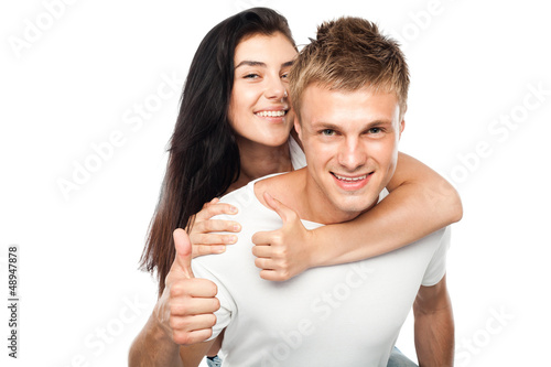 Happy young couple with his thump up