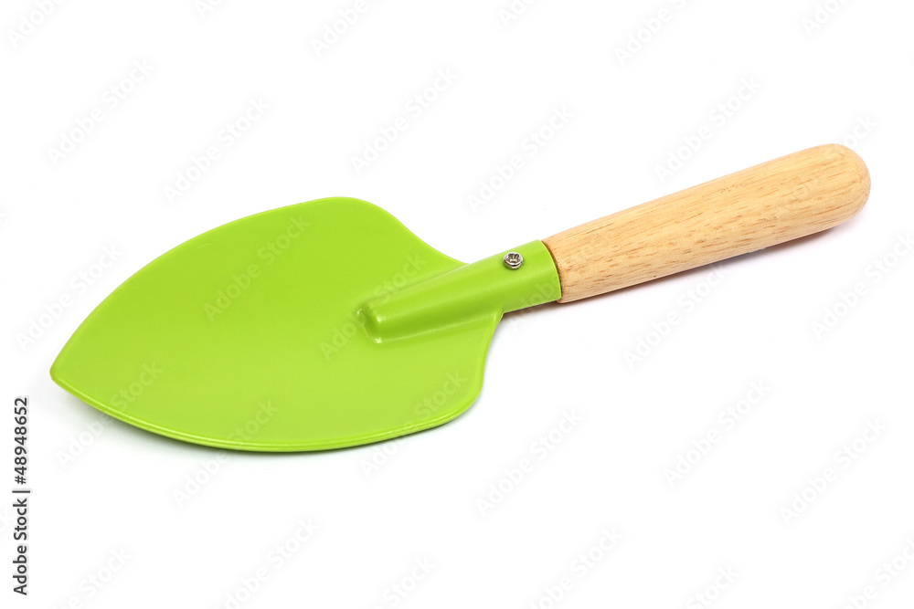 A small garden spade in green on a white background A small garden spade in green on a white background