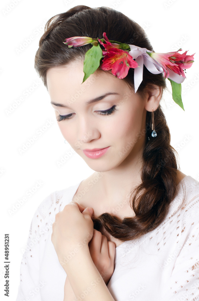 Portrait of the beautiful girl with flowers in hair