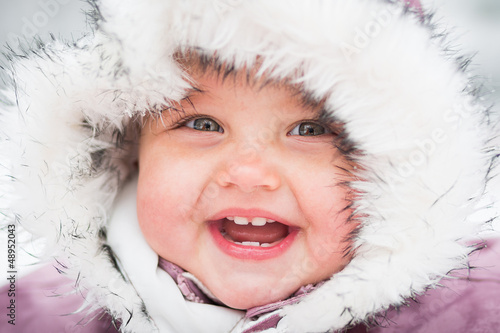 Happy baby on the winter background