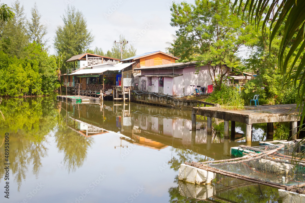 Small village house at the water in Thailand Small village house at the water in Thailand
