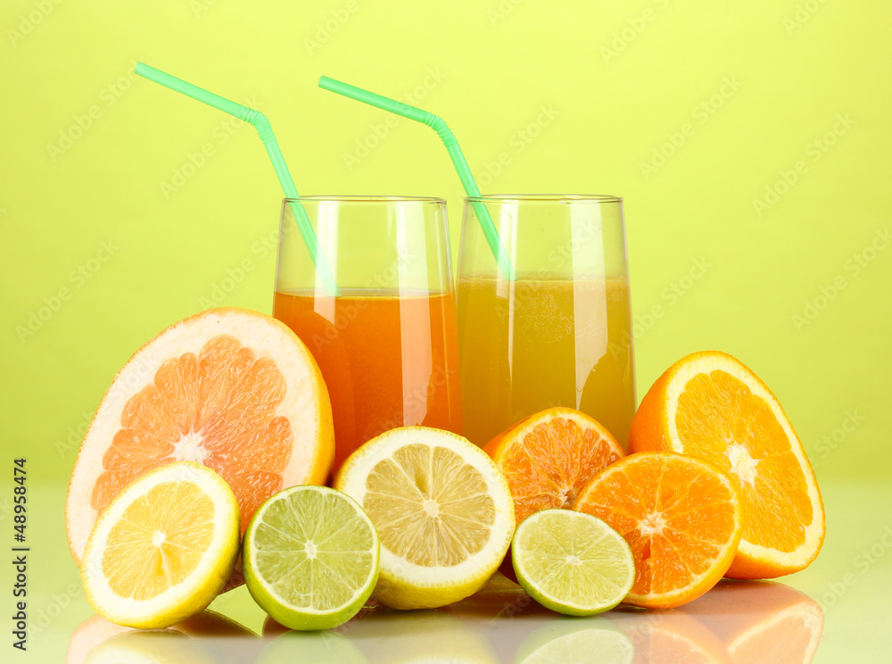 Lots ripe citrus with juices on green background Lots ripe citrus with juices on green background