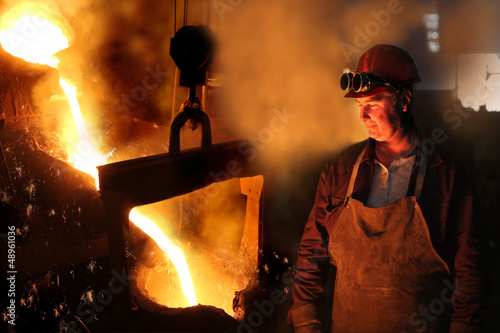 Hard work in a foundry, melting iron photo