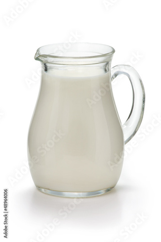 Jug with fresh milk on a white