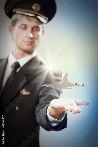 Image of pilot with plane in hand photo