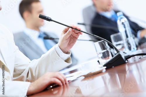 Hands of businessman holding microphone